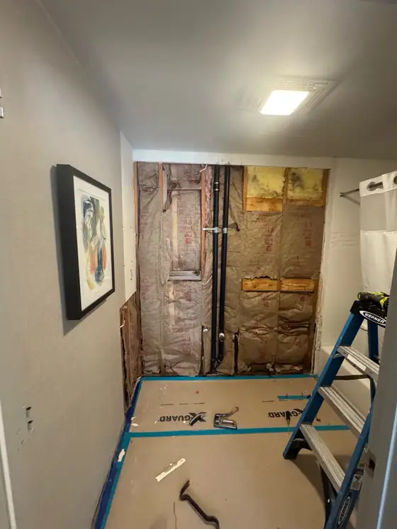 Rebuilt wall with the plumbing renewed, ready to close up