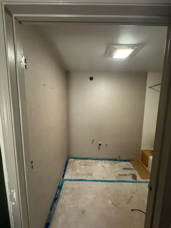 The bathroom masked off with the new surfaces ready to finish