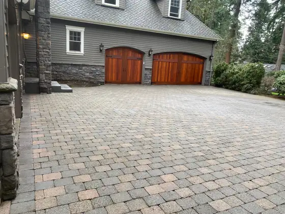 The cleaned paver driveway in front of the garage doors after washing