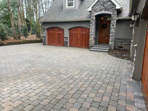 Clean paver driveway and entry after restoration, seen from the turn
