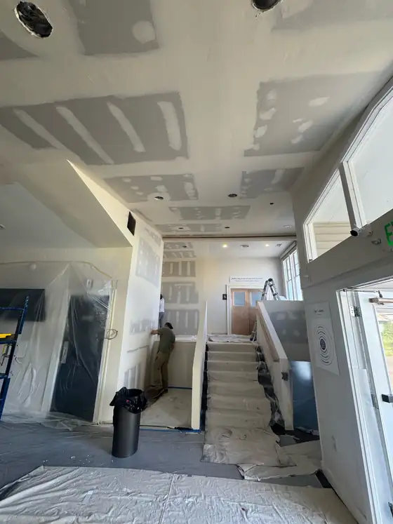 Drywall taping and jointing through the main stairwell