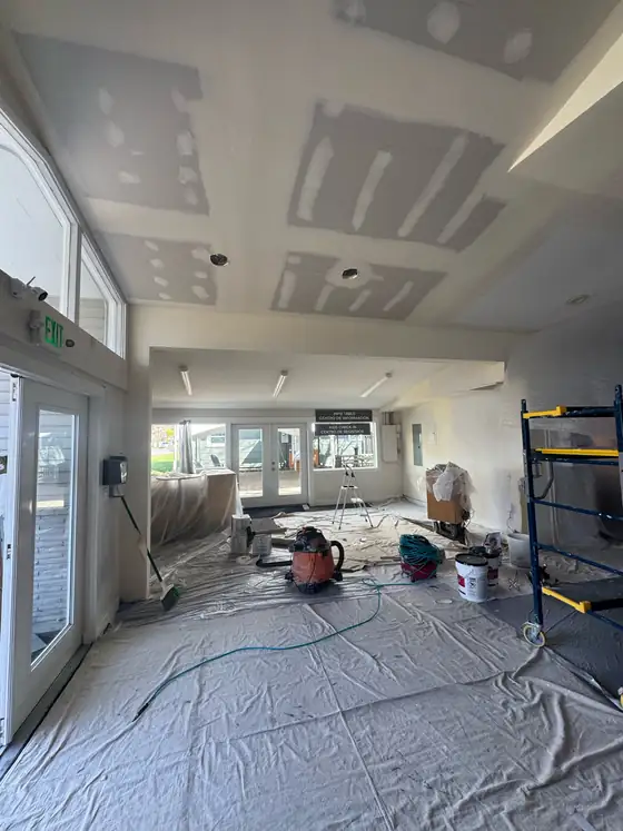 Ceilings and walls being taped out in the open-plan space