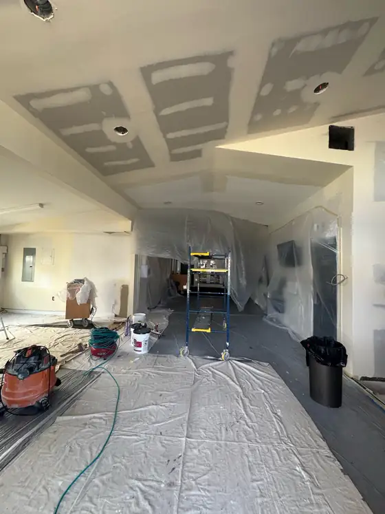 Floors covered and the room part way through drywall finishing