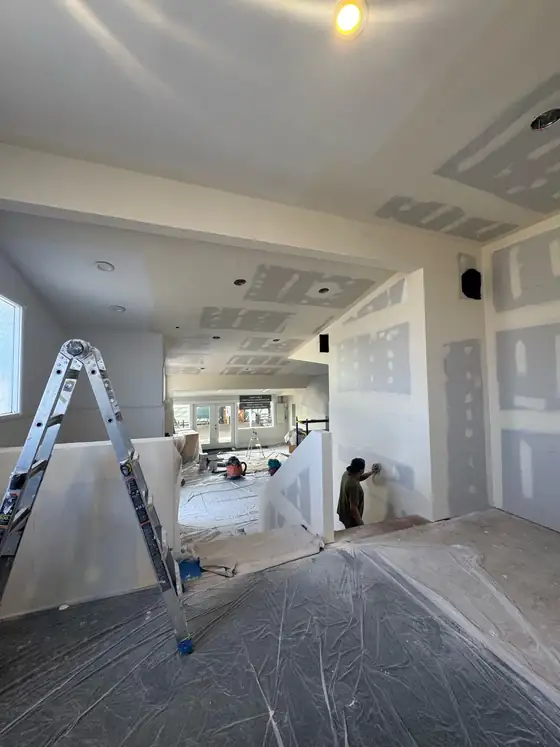 Ladders and drop cloths through the space during finishing