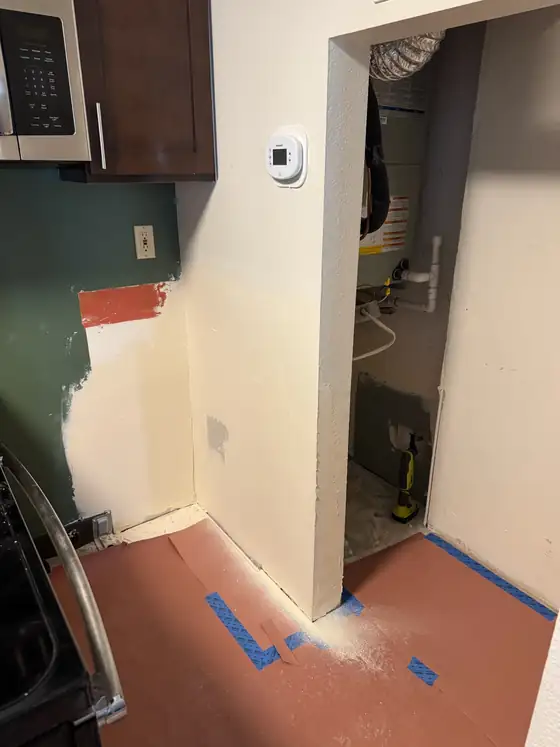 The alcove beside the range stripped back before the new cabinet went in