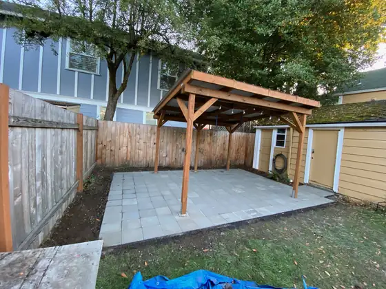 Completed patio cover and paver patio from across the garden