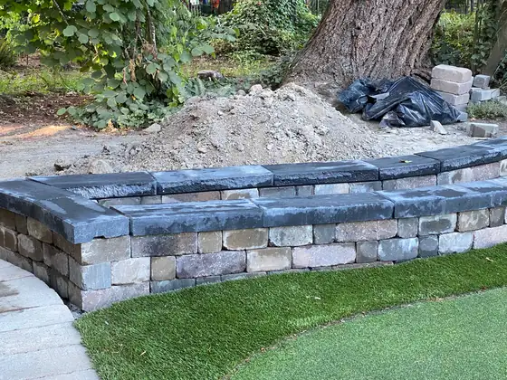 The finished curved planter wall seen from the lawn