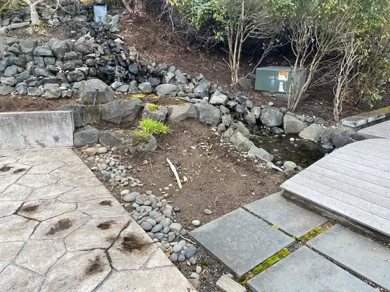 Rock edging and stepping stones going in beside the water