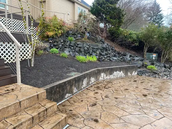Retaining wall, fresh planting beds and stamped concrete steps