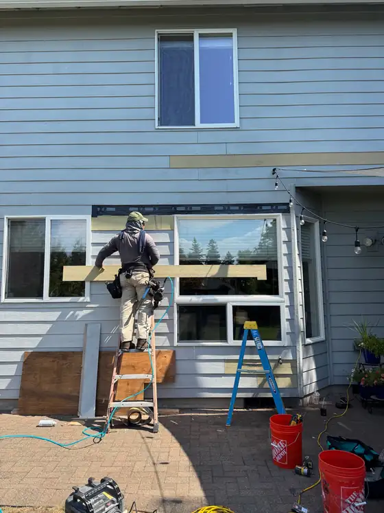 Working on the siding above the rear windows