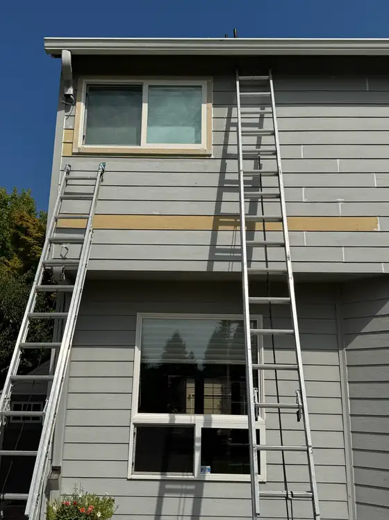 New siding going on around a first-floor window