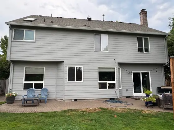 Completed siding and exterior paint across the back of the house